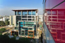 The Arora tower reflected in the coloured glazing of the Airtel Building, Gurgaon