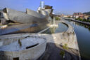 A long shot of the Guggenheim at Bilbao with the spider sculpture in the foreground
