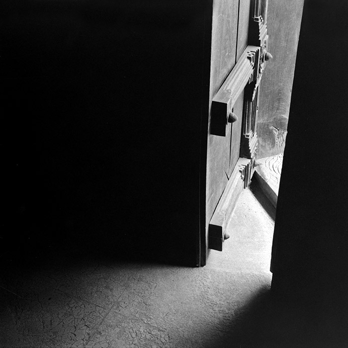 A partly open door letting in light at Padmanabhapuram Palace, India
