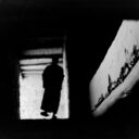 A monk walks down a palace staircase in Ladakh, India