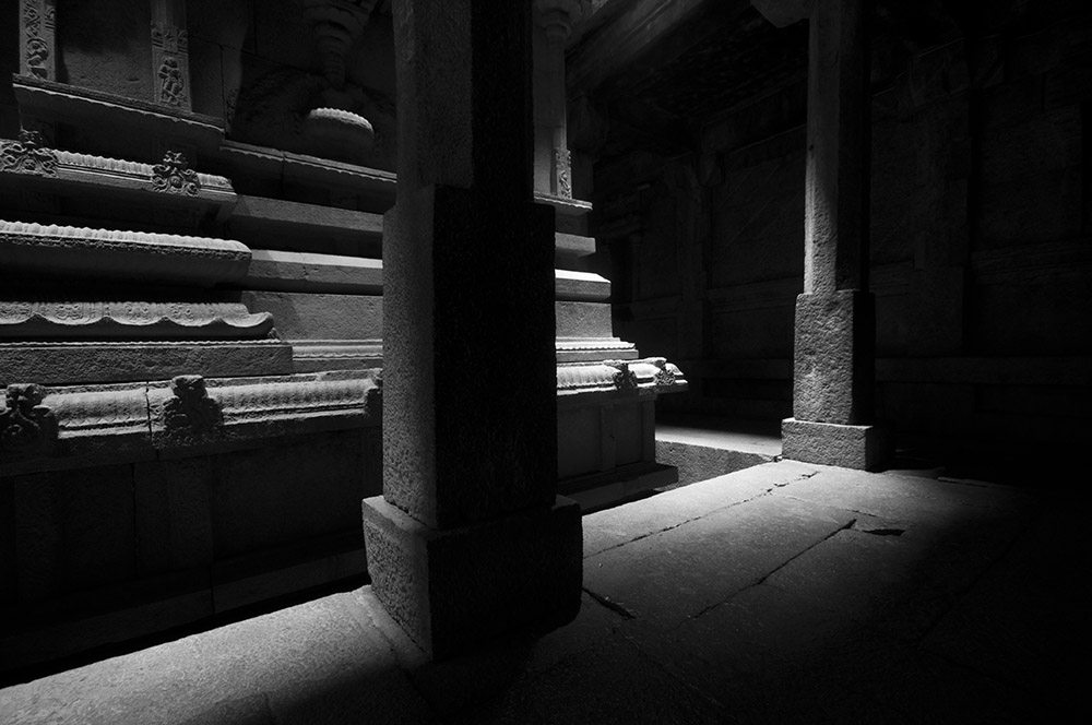 Light filtering down into the basement of a Hindu Temple revealing the stone carving