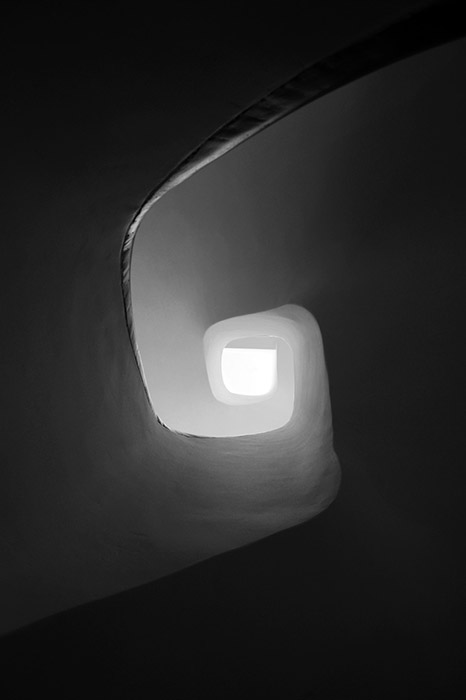 Swirling spiral of a staircase looking up to the light