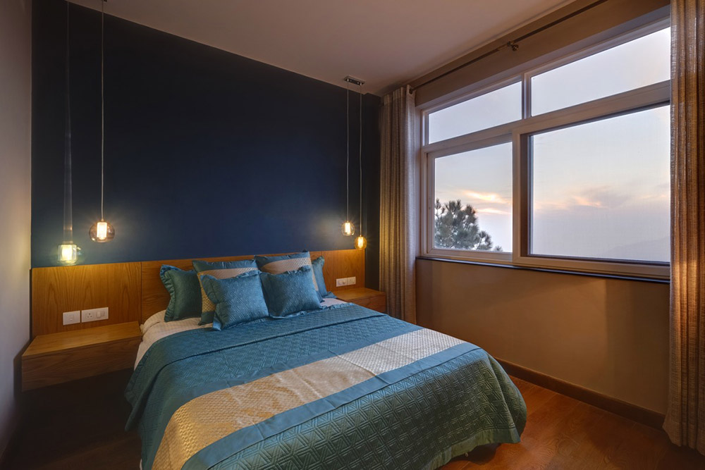 A bedroom overlooking the valley at the Tata Myst project at Himachal Pradesh